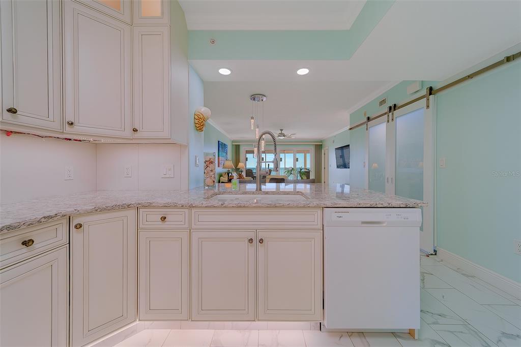 16450 Gulf Boulevard, Unit 565 North Redington Beach, FL 33708 - Photo 12 of 52 a kitchen with white cabinets and sink