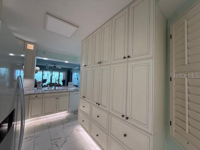 16450 Gulf Boulevard, Unit 565 North Redington Beach, FL 33708 - Photo 14 of 54 a large white kitchen with granite countertop white cabinets and stainless steel appliances