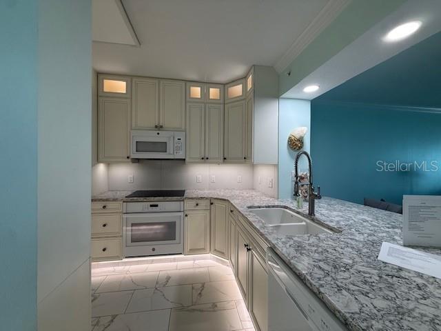 16450 Gulf Boulevard, Unit 565 North Redington Beach, FL 33708 - Photo 15 of 54 a kitchen with granite countertop a sink stainless steel appliances and cabinets