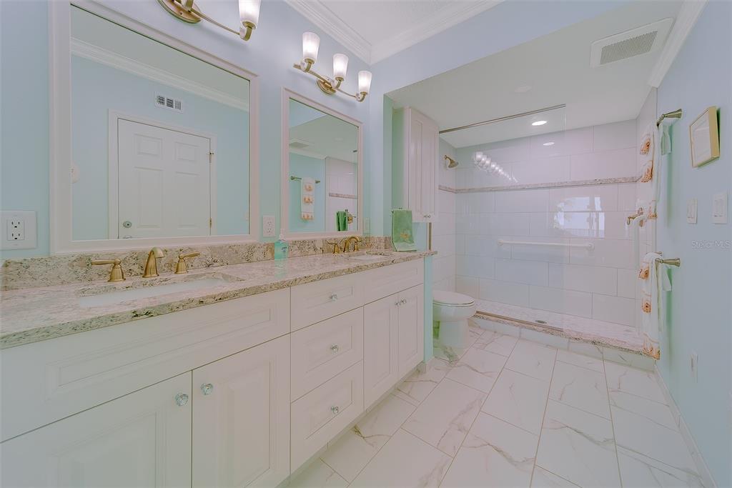 16450 Gulf Boulevard, Unit 565 North Redington Beach, FL 33708 - Photo 22 of 52 a bathroom with a granite countertop sink mirror and double