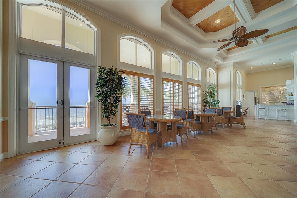 16450 Gulf Boulevard, Unit 565 North Redington Beach, FL 33708 - Photo 32 of 52 a group of people sitting in living room next to a large window