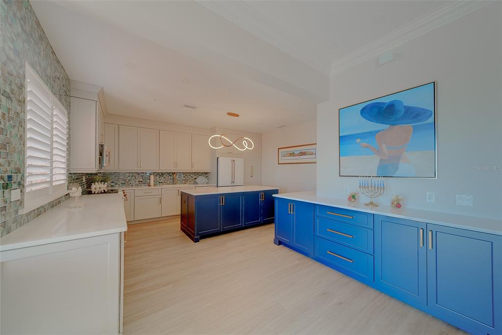 16450 Gulf Boulevard, Unit 565 North Redington Beach, FL 33708 - Photo 35 of 52 a kitchen with stainless steel appliances sink stove and cabinets