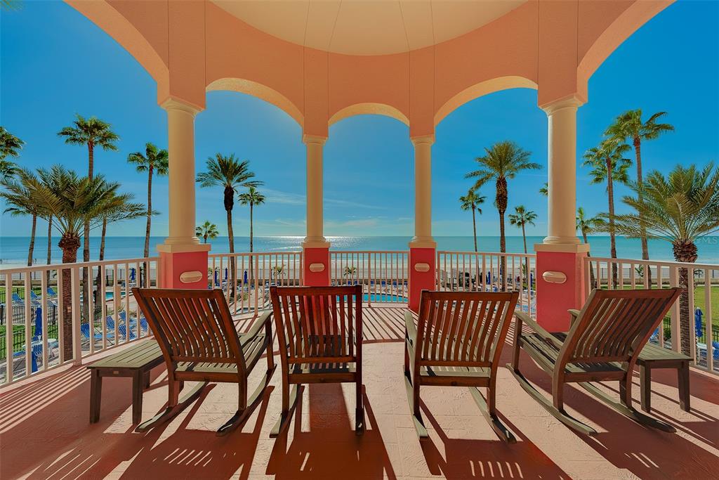 16450 Gulf Boulevard, Unit 565 North Redington Beach, FL 33708 - Photo 41 of 52 a view of a balcony with chairs and wooden floor