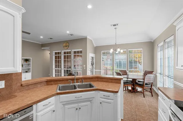 a kitchen with a sink and large windows