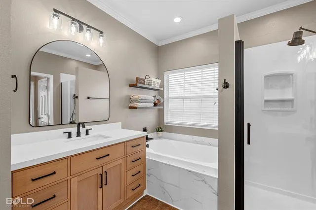 a bathroom with a tub a double vanity sink and a mirror