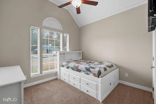 a bed sitting in a bedroom next to a window