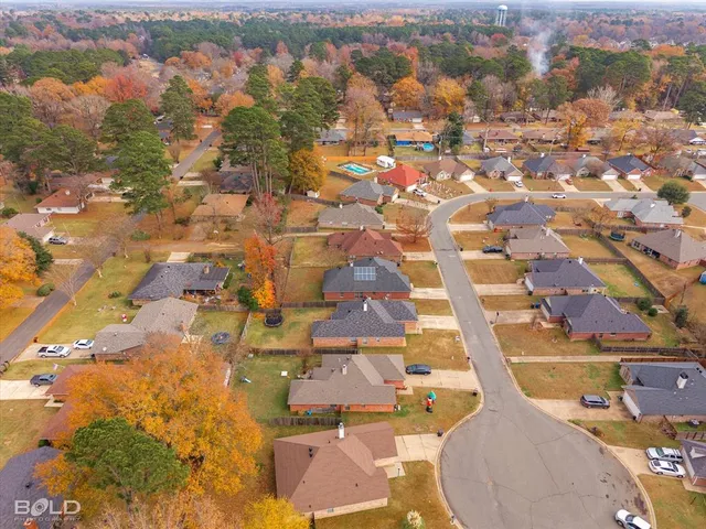 an aerial view of a houses with a swimming pool