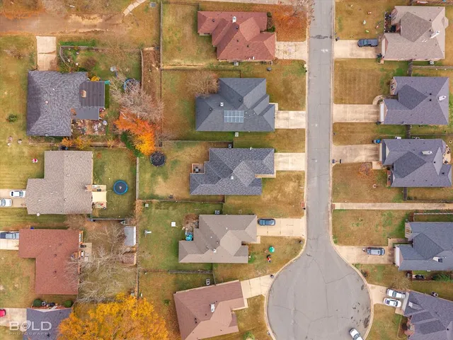an aerial view of residential houses with outdoor space