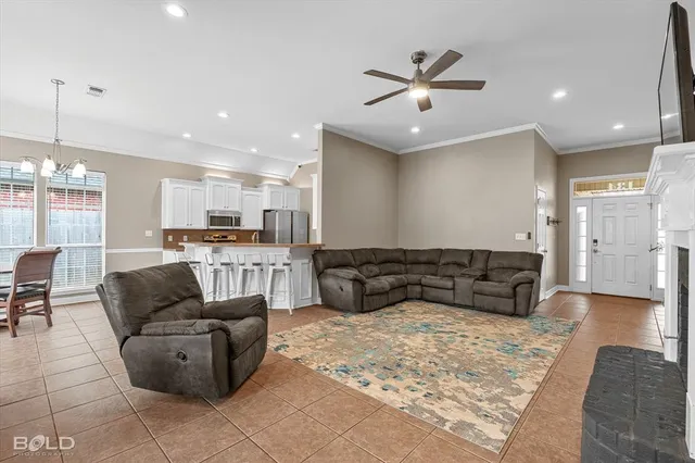 a living room with furniture and kitchen view