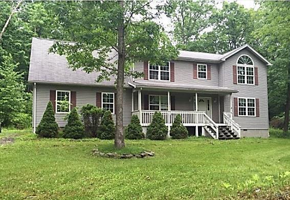 204 Alpine Road Henryville, PA 18332 - Photo 1 of 13 a front view of a house with a yard and porch