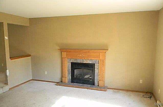 204 Alpine Road Henryville, PA 18332 - Photo 6 of 13 a living room with a fireplace