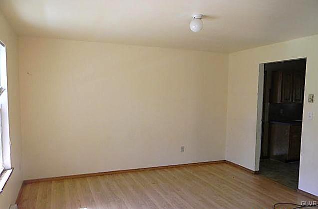 204 Alpine Road Henryville, PA 18332 - Photo 8 of 13 an empty room with wooden floor and windows