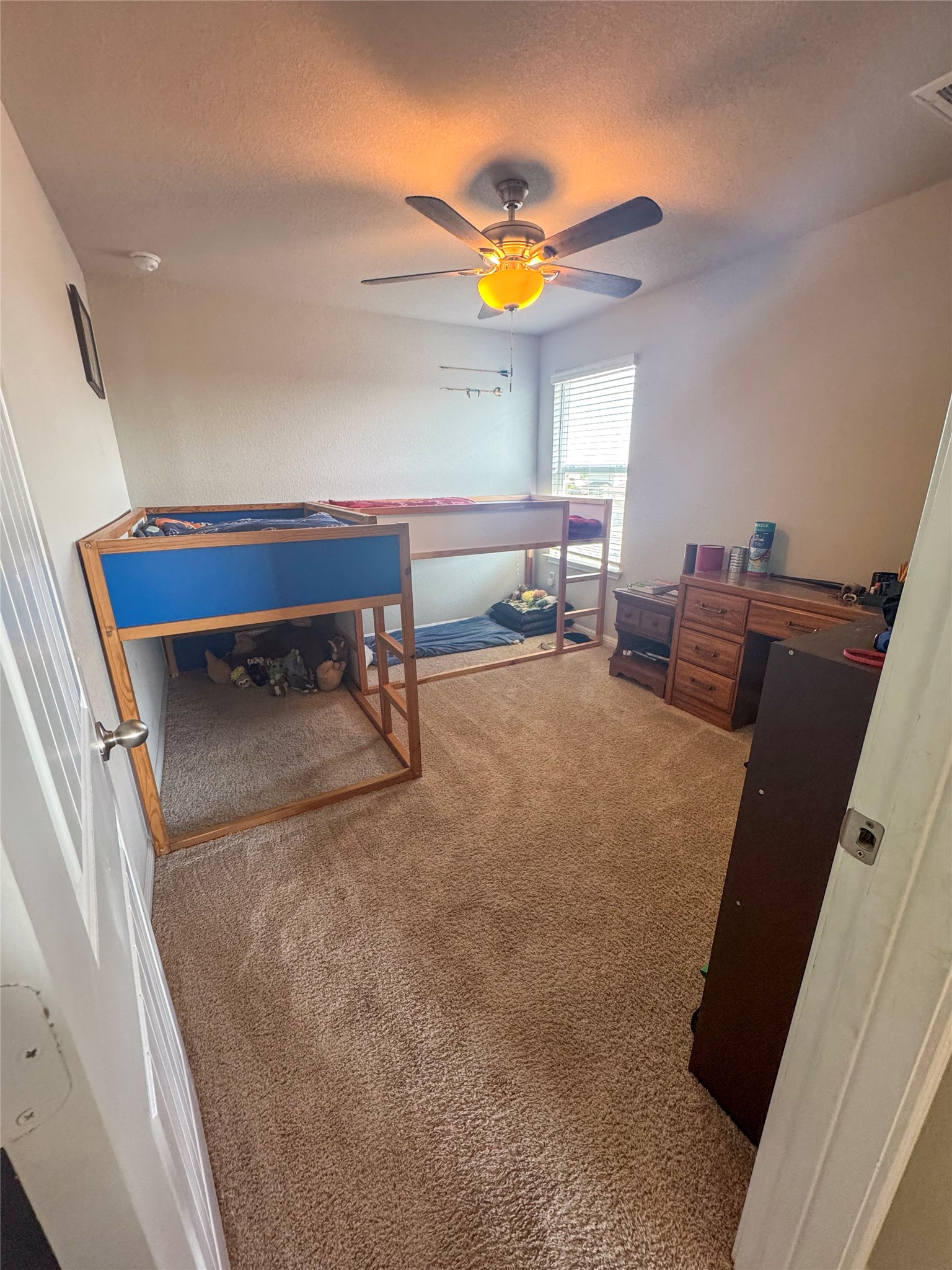 107 Hamilton Pool Lane Bastrop, TX 78602 - Photo 16 of 22 Bedroom featuring light carpet and ceiling fan.