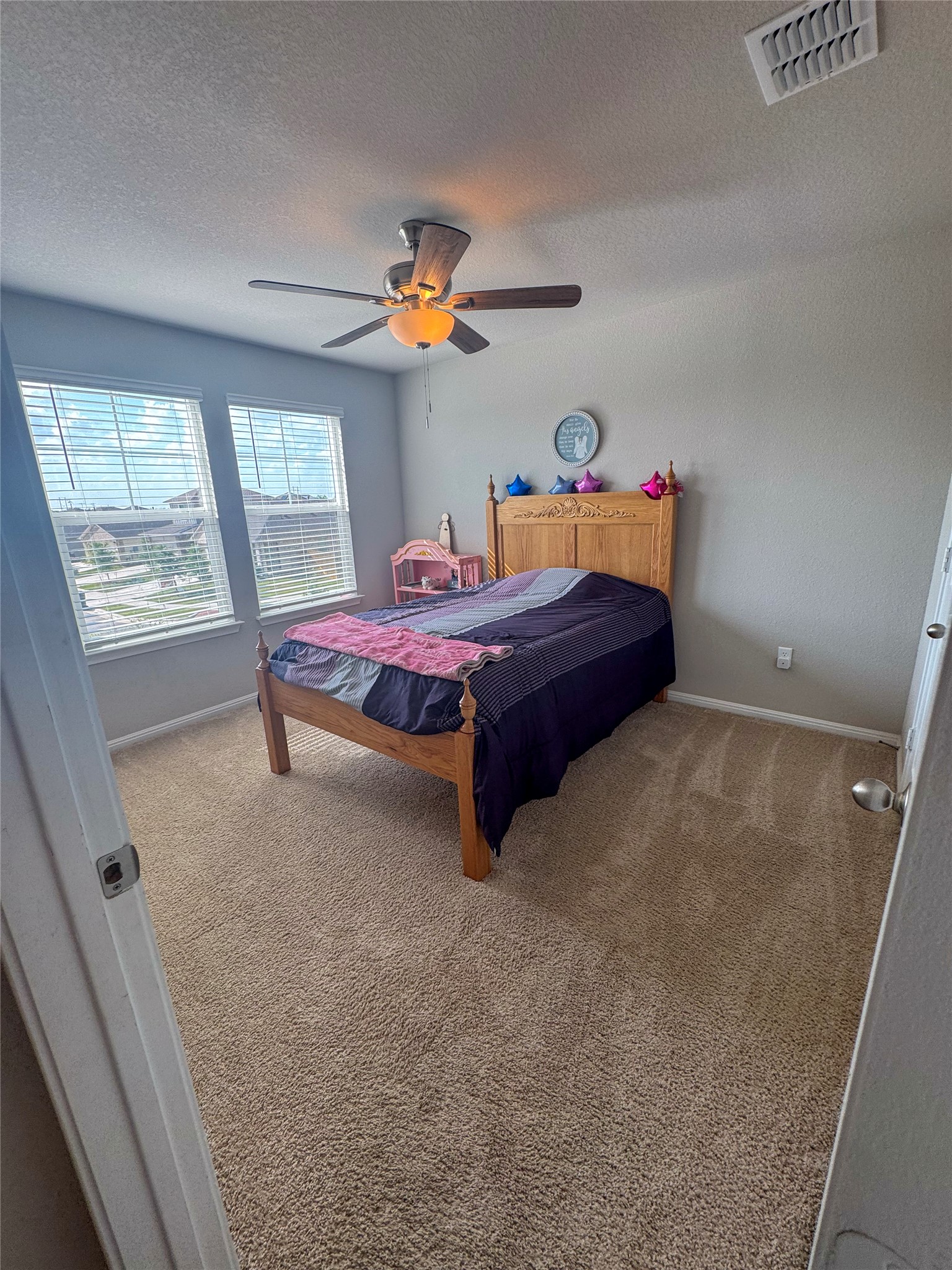 107 Hamilton Pool Lane Bastrop, TX 78602 - Photo 17 of 22 Bedroom featuring light carpet and ceiling fan.