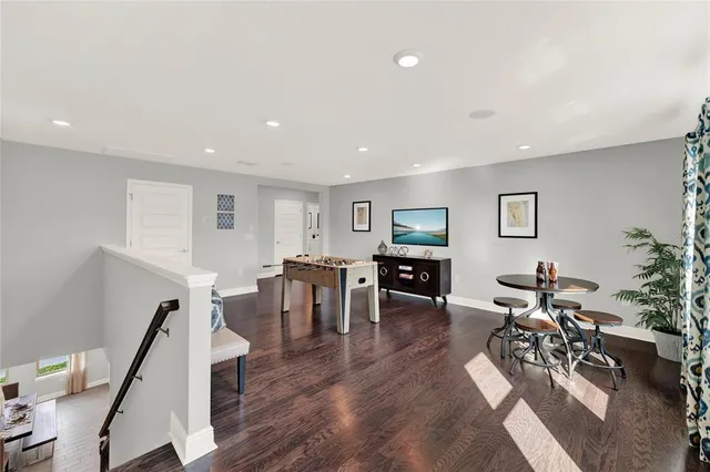 a living room with furniture window and wooden floor