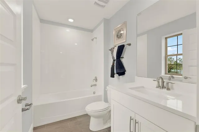 a bathroom with a sink and mirror with toilet