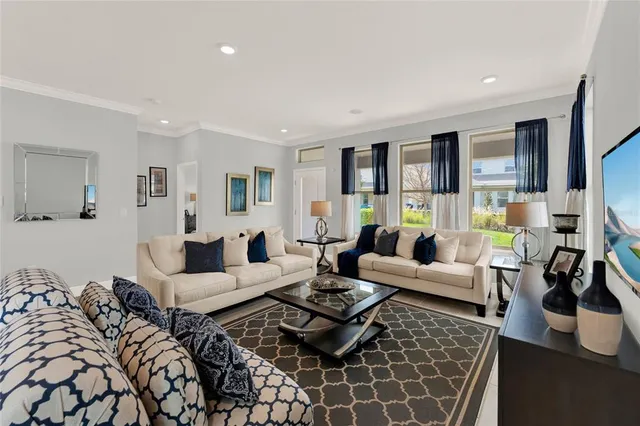 a living room with furniture potted plant and a window