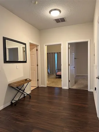 a view of a room with wooden floor and bench