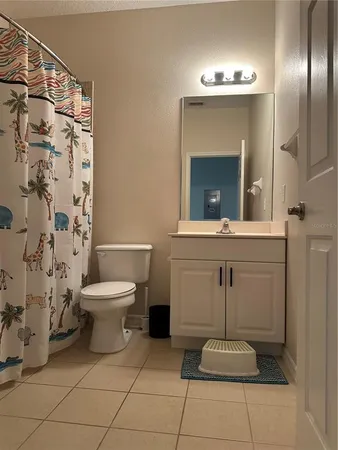 a bathroom with a toilet sink and shower