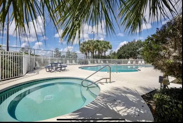 a swimming pool with outdoor seating and yard
