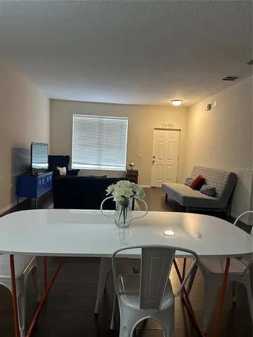 a kitchen with a table chairs and a dining table