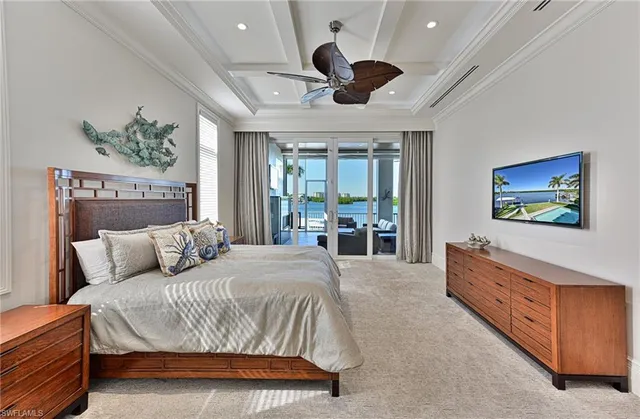 a bedroom with a large bed and a flat screen tv