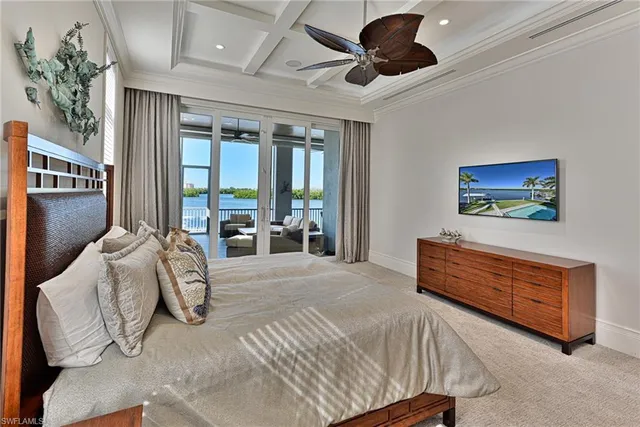 a bedroom with furniture and a large window