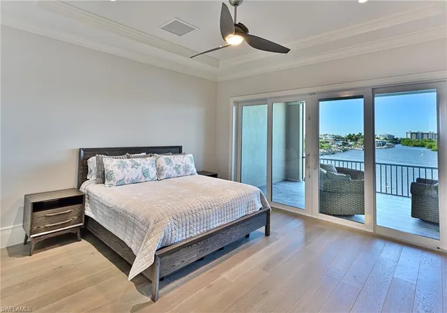 a large bed sitting in a bedroom next to a window