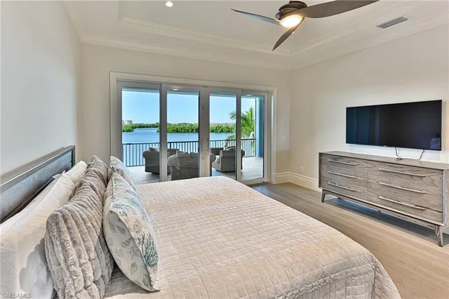 a bedroom with a bed and glass door