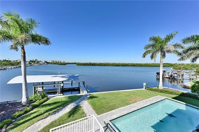 a view of a lake with a table and chairs