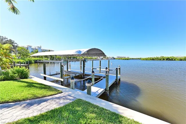 a view of a house with patio and a yard