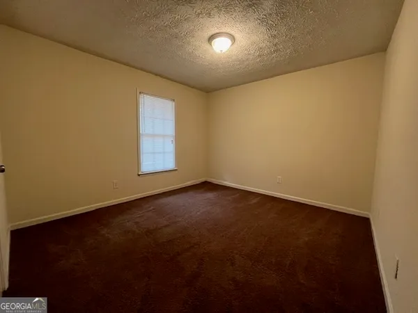 an empty room with a empty space and window