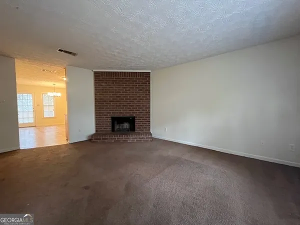 a view of empty room with a fireplace