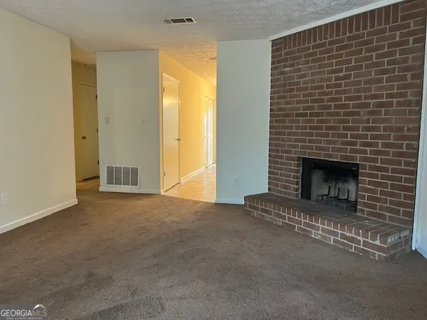 a view of empty room with a fireplace