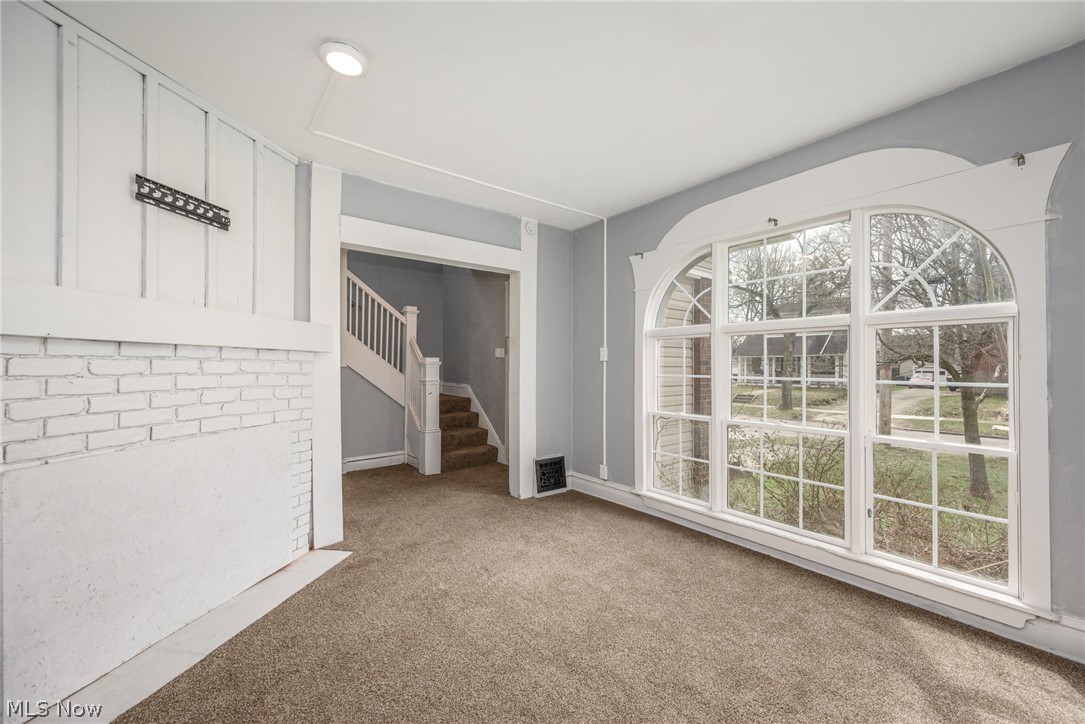 1603 Hampton Road Akron, OH 44305 - Photo 9 of 50 Unfurnished room with stairs and light colored carpet