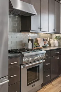 a kitchen with stainless steel appliances granite countertop a stove and a microwave