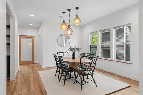 a view of a dining room with furniture and window