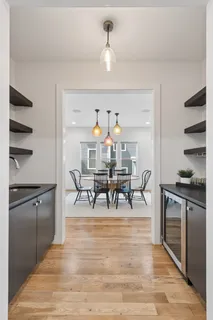 a view of a dining room and kitchen with a wooden floor