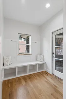 a view of an empty room with cabinet and a window
