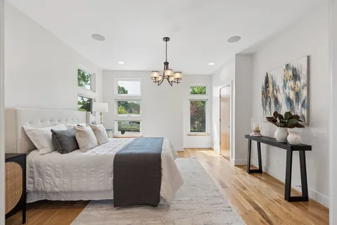 a living room with furniture and a chandelier