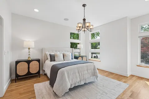 a spacious bedroom with a bed and a window