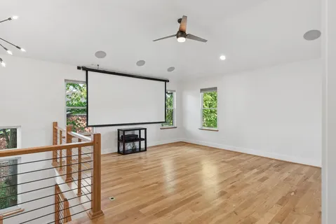 a view of room with window and wooden floor