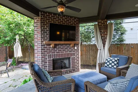 a living room with furniture a flat screen tv and a fireplace