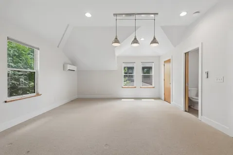 an empty room with windows and closet
