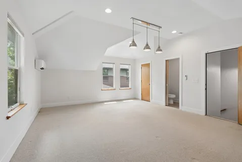 an empty room with windows and closet