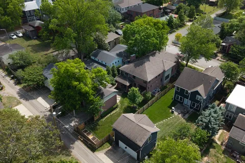 an aerial view of a house with garden space and street view