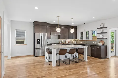 a large kitchen with a table and chairs