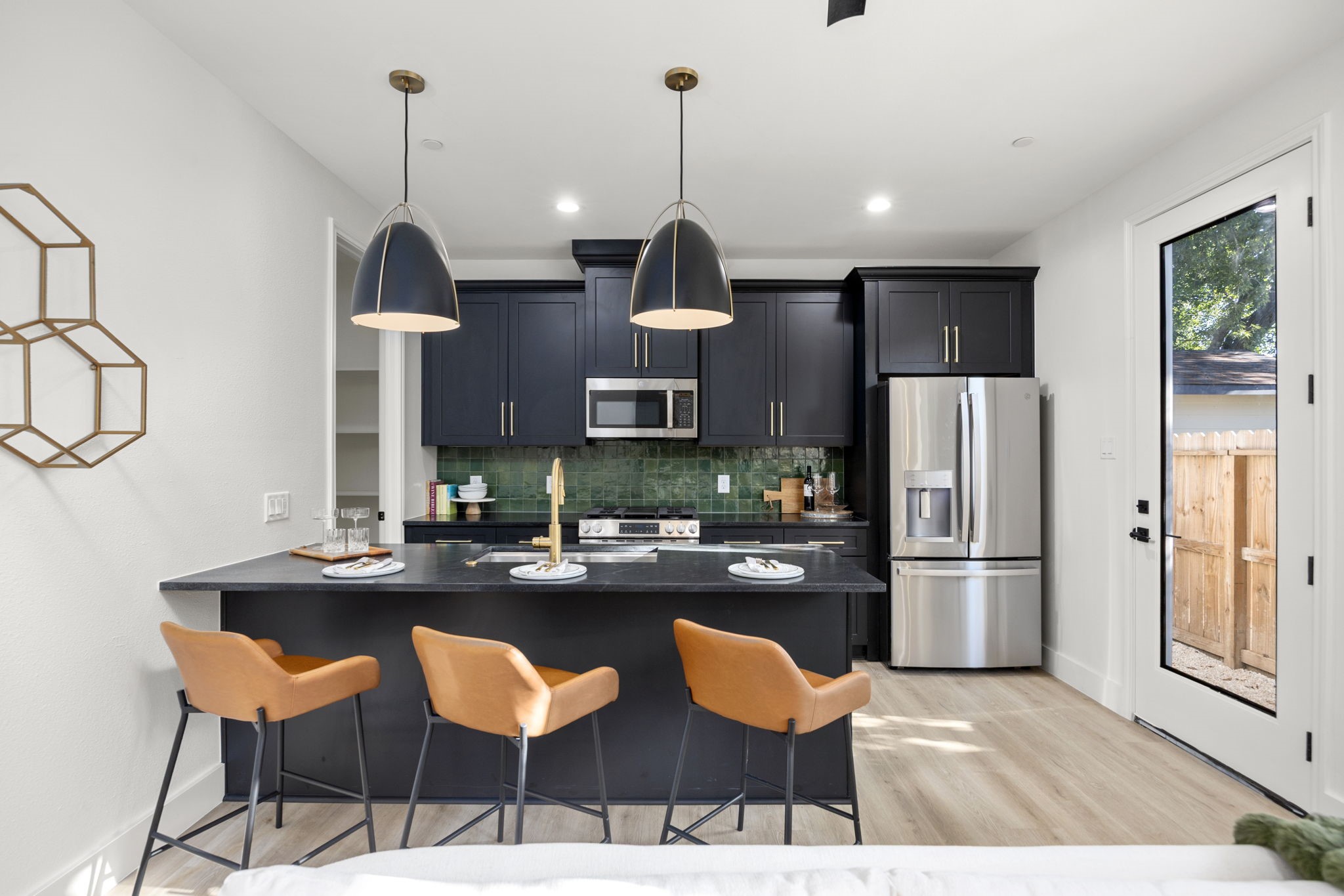 4611 Dewberry Street, Unit B Houston, TX 77021 - Photo 6 of 24 a kitchen with stainless steel appliances kitchen island granite countertop a refrigerator and a sink