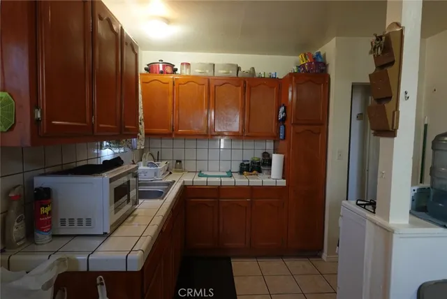 a kitchen with stainless steel appliances a refrigerator sink and cabinets