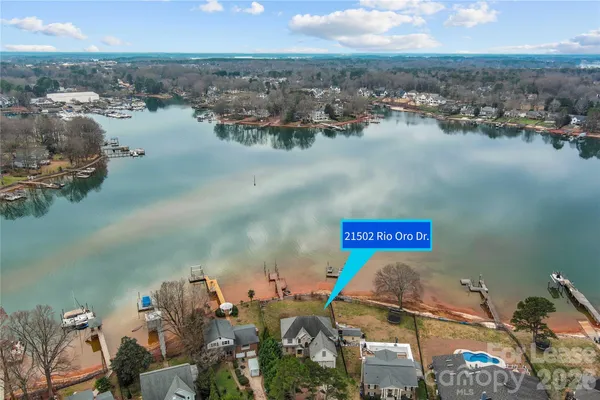 an aerial view of a house with garden space and lake view